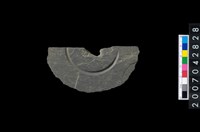 藏品(石環製作材料-中央帶啄孔與旋截痕打製圓板殘件)的圖片