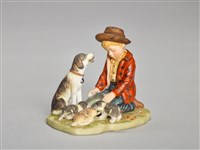 藏品(男孩子在餵食三隻小狗)的圖片